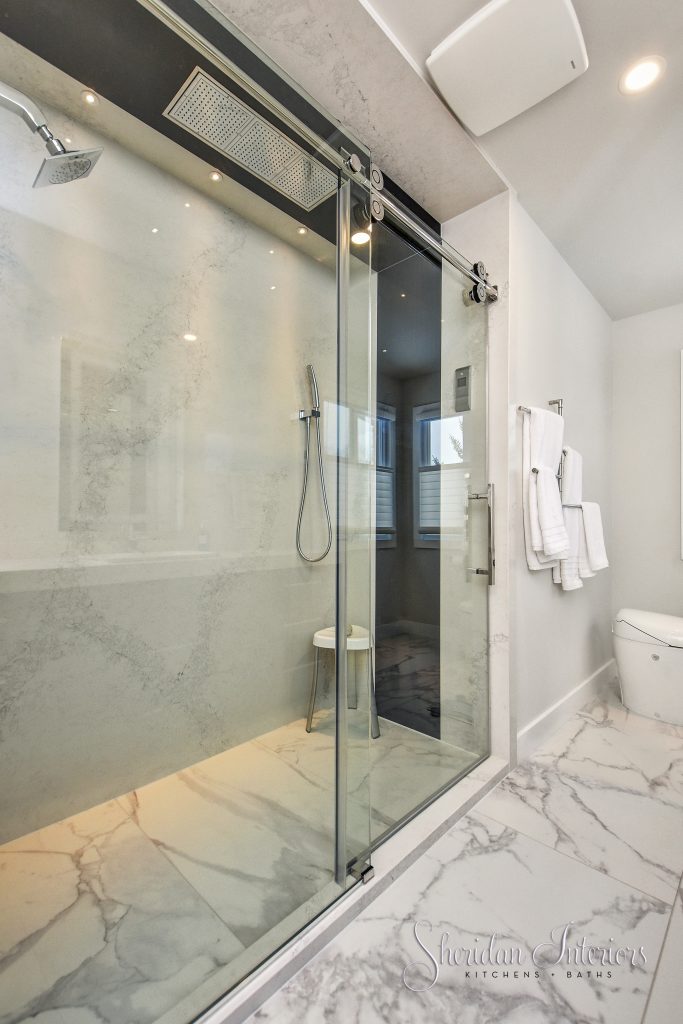 contemporary bathroom with roll in shower and large format porcelain tiles on floor. Quartz panels for shower walls interior designer ottawa interior designer cornwall