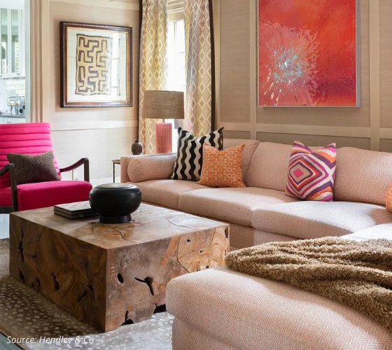 Contemporary living room in varying shades of peach, pink and fuchsia with bold coloured art and accents
