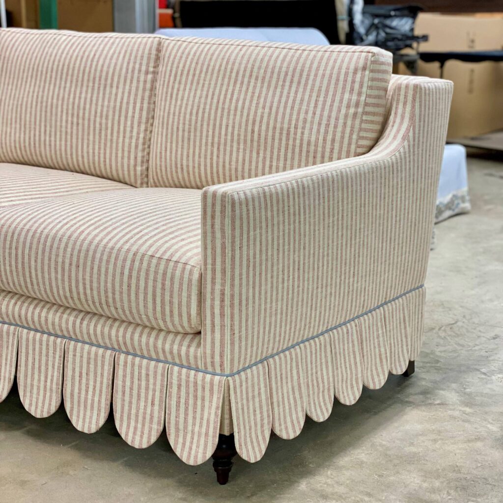 Custom-made sofa in a ticking tripe, blue welt and scalloped skirt. by O Henry House for Julie McGlynn.  Custom furniture design in Cornwall, Ontario and Ottawa. 