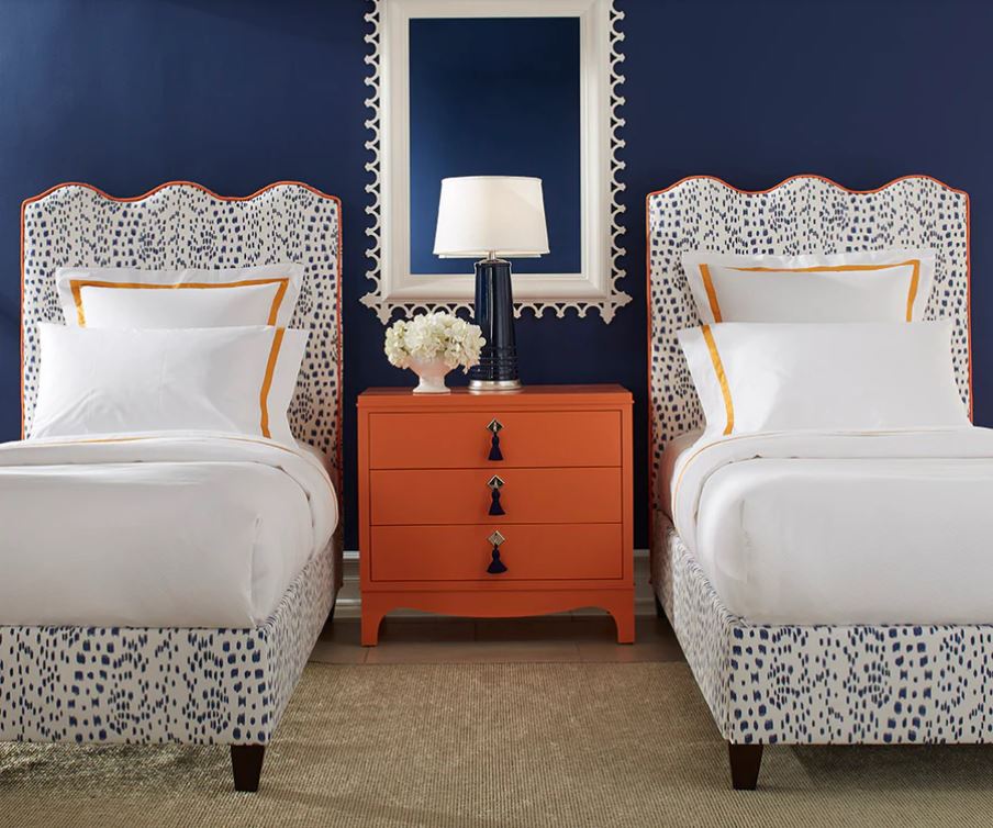 Custom-made twin beds with scalloped headboard, in navy, orange and white. Sheridan Interiors, luxury interior designer in Cornwall also serving Ottawa and Eastern Ontario